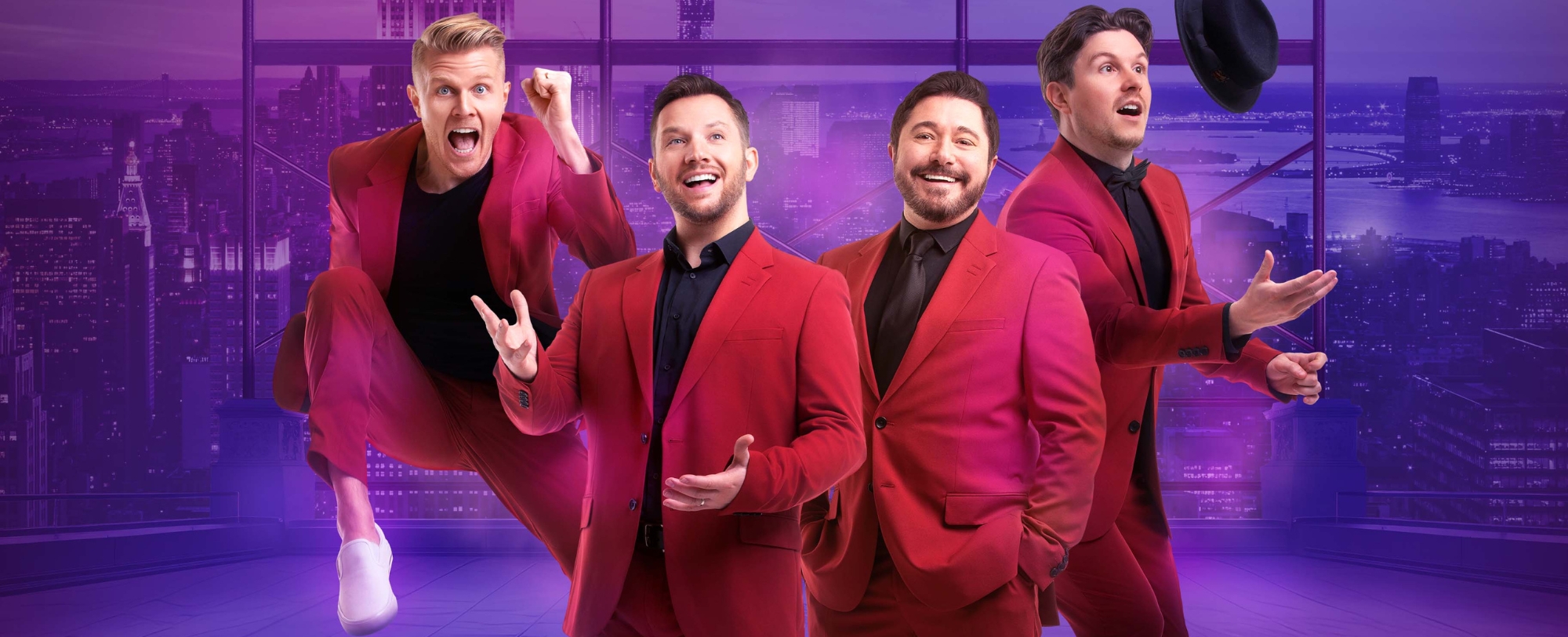 group photo of musical ensemble each wearing a read suit and black shirt.